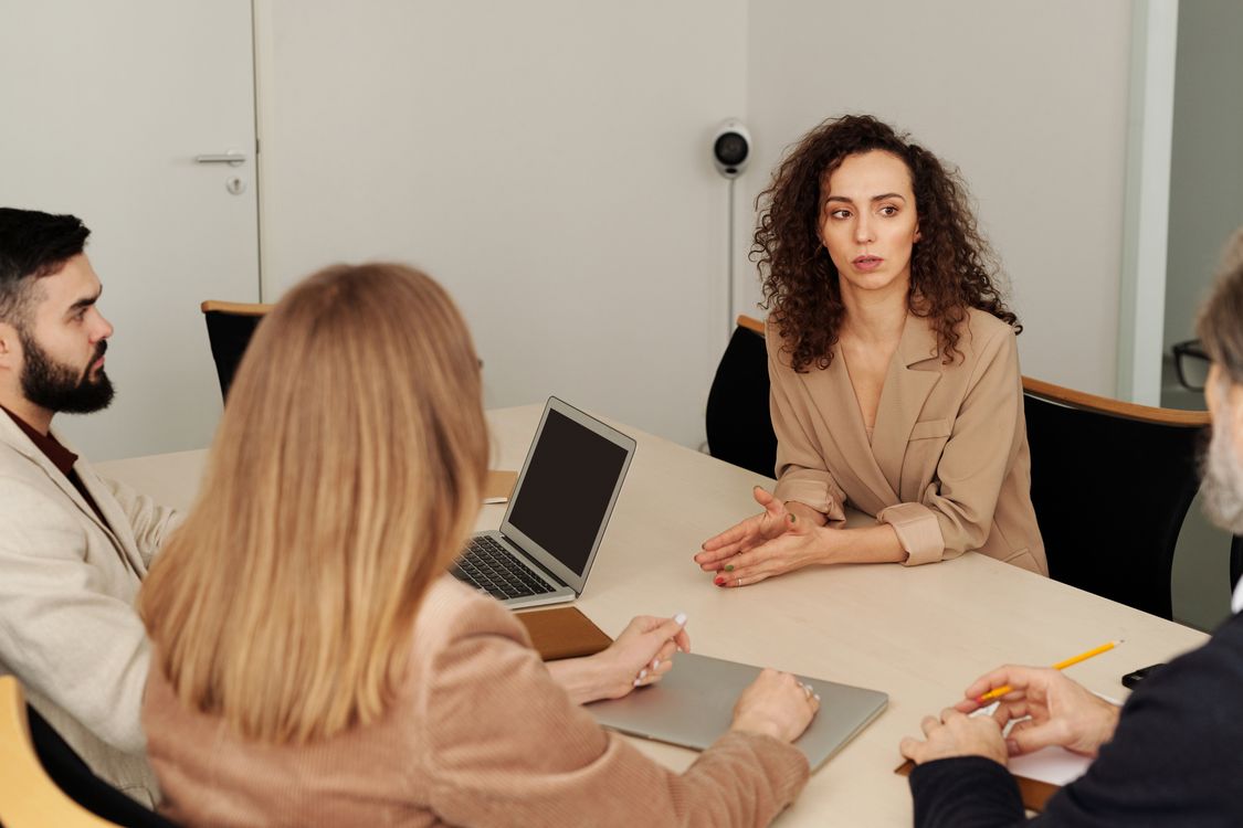Professionals discussing work around a meeting table